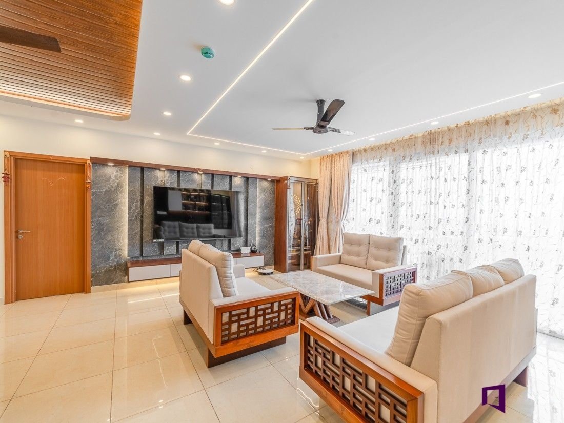 Warm-toned living room with wood panelled TV wall and green upholstered sofa